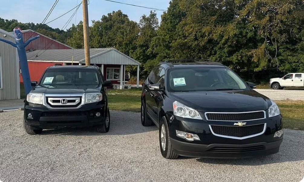 Two vehicles parked at an automotive lot